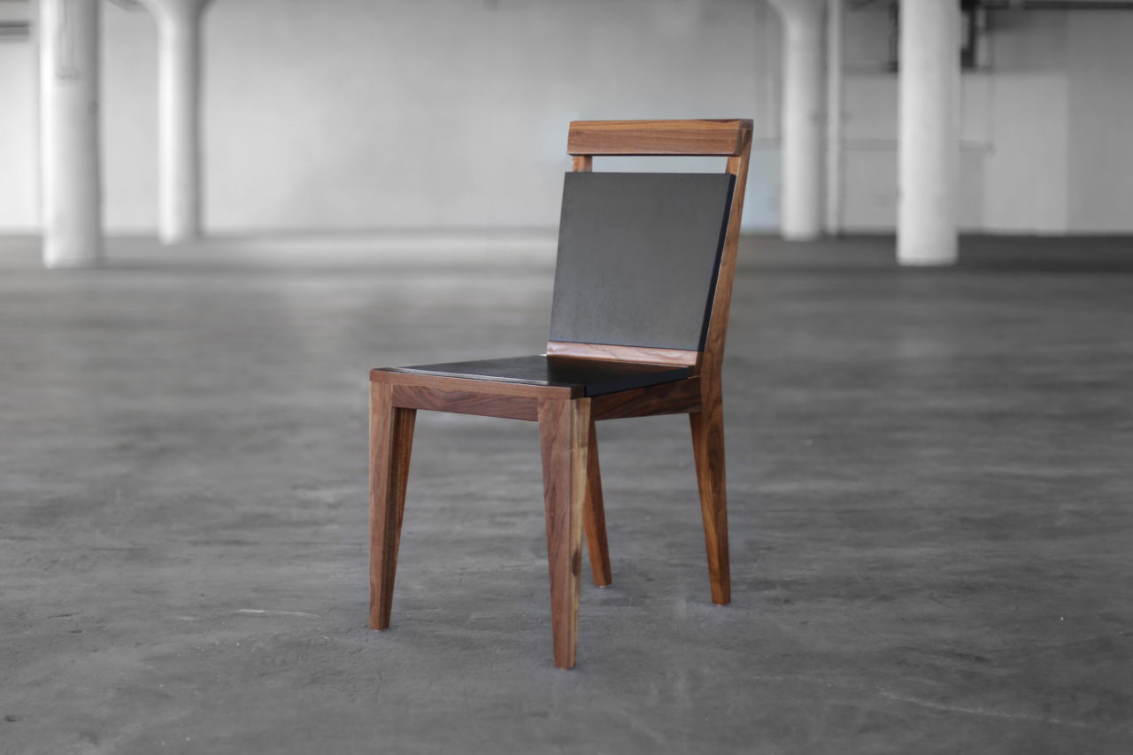 SENTIENT Angles contemporary luxury dining chairs in walnut with black back and seat in warehouse loft