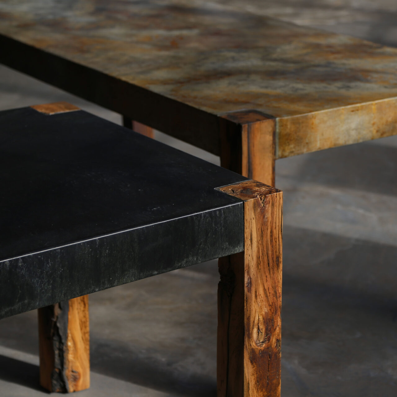 A custom made table by SENTIENT Furniture, blending natural wood with a zinc and concrete finish. The combination of materials provides an earthy, industrial look, perfect for a modern space.
