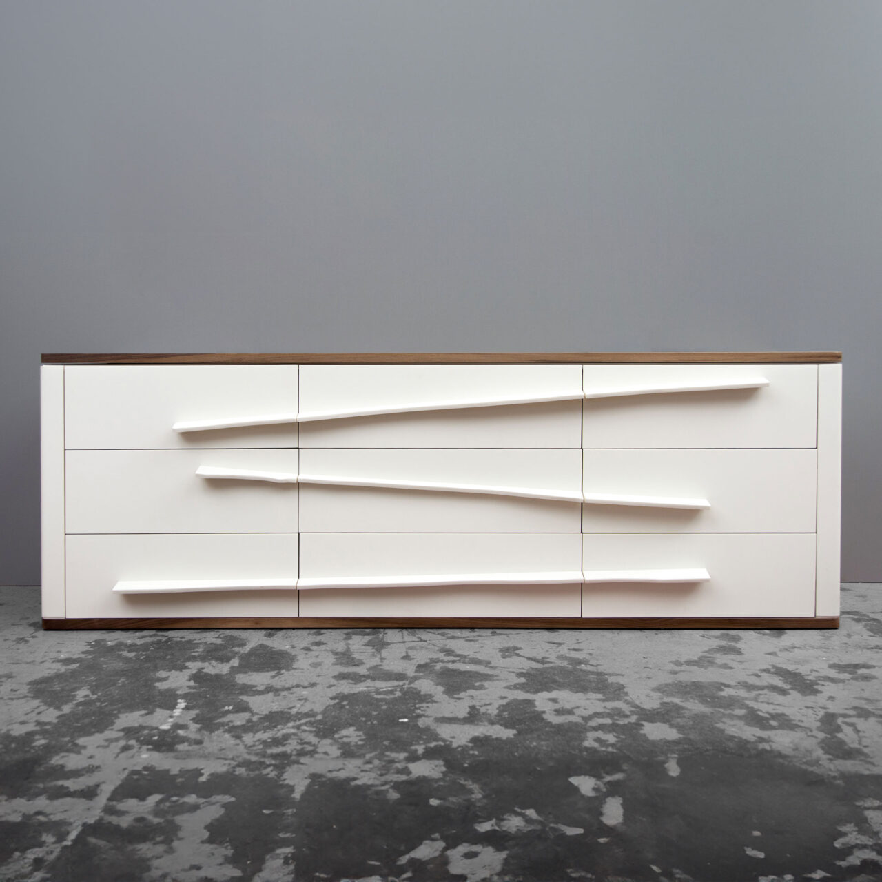Modern white SENTIENT Niagara dresser with unevenly aligned drawers, creating a dynamic visual effect.